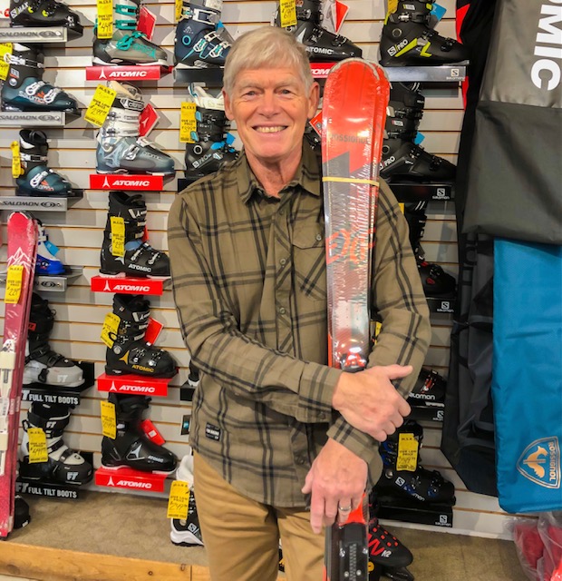 The owner of College Sports, Bob Hinton standing with a set of skis